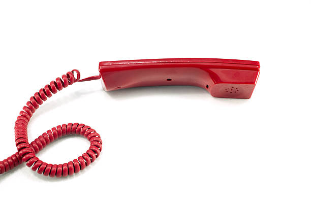 istock Red telephone receiver isolated on a white 501149833