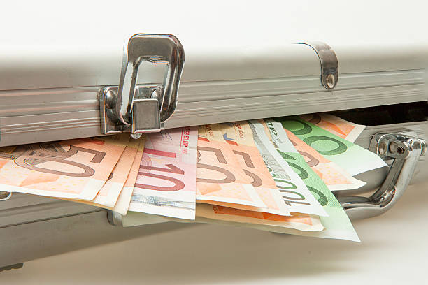 Silver suitcase with Euro notes showing stock photo