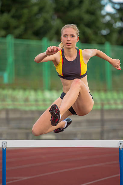 istock Young Women at 400 m Hurdle Race 501154053