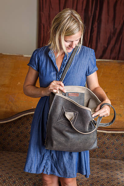 Blonde Woman With Gray Leather Purse stock photo