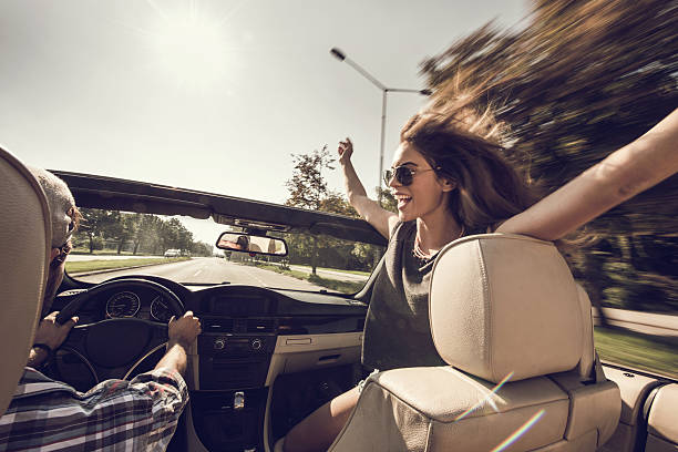 istock Cheerful woman having fun while driving in cabriolet. 501155172