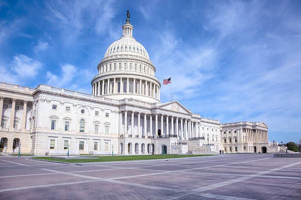 istock United States Capitol under Blue Sky with Fluffy White Clouds 501155639