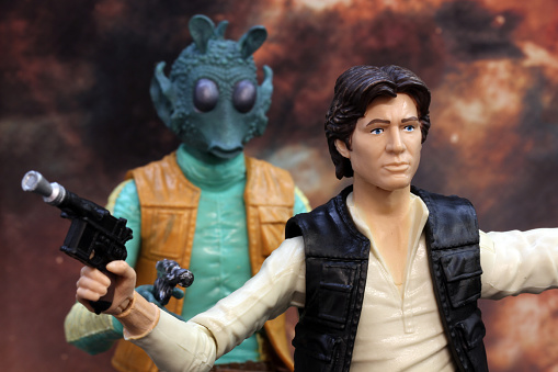 Vancouver, Canada - November 15, 2015: Models of Greedo, an alien bounty hunter and Han Solo, Smuggler from the Star Wars film franchise. The toys are part of the Black Series, from Hasbro.  The background is created by Funko and part of the Legacy Collection.