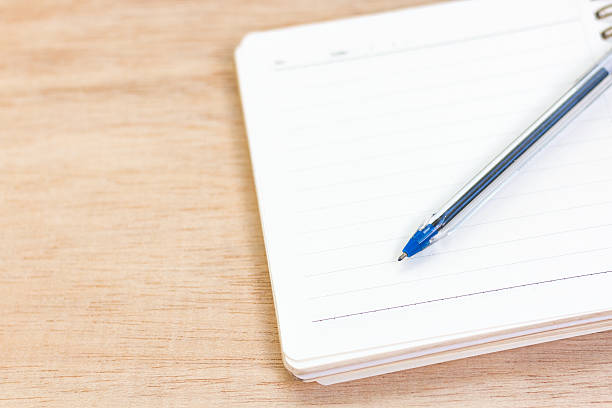 istock Empty notebook and pen on wooden background 501156666