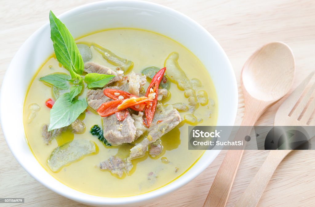 Green curry with pork   and woodden fork spoon Baking Stock Photo