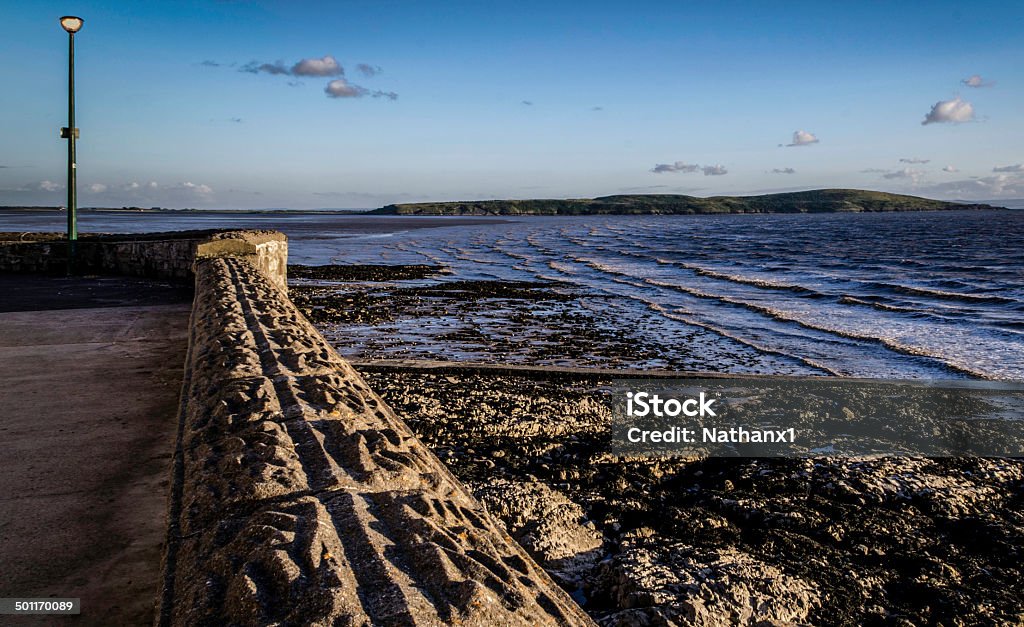 landscape shot of sea wall at low tide, colour image landscape shot of sea wall at low tide, colour image taken at dusk Beach Stock Photo