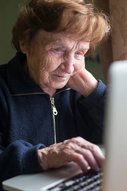 istock Very elderly woman using laptop computer at home. 501170873