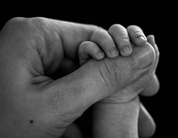 istock B&W Daughter holding Hand of Father 501171329