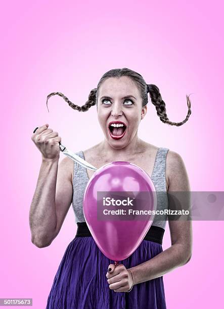Angry Young Woman Bursting A Balloon With A Knife Stock Photo - Download Image Now - Balloon, Exploding, Adult