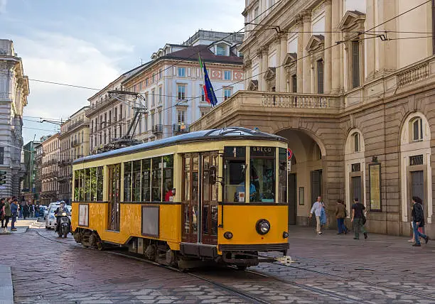 Photo of Old tram passing at La Scala theatre in Milan