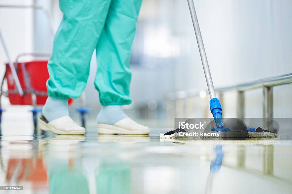worker cleaning floor with mop Floor care and cleaning services with washing mop in sterile factory or clean hospital  Cleaning Stock Photo