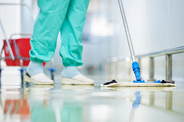worker cleaning floor with mop stock photo