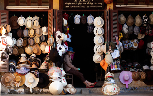 Hoi An, Vietnam - May 13, 2012: Abstract hat shop show many kind of hat at front of ancient wooden house of antique market, Hoian is famous place for travel, Viet Nam, May 15, 2012