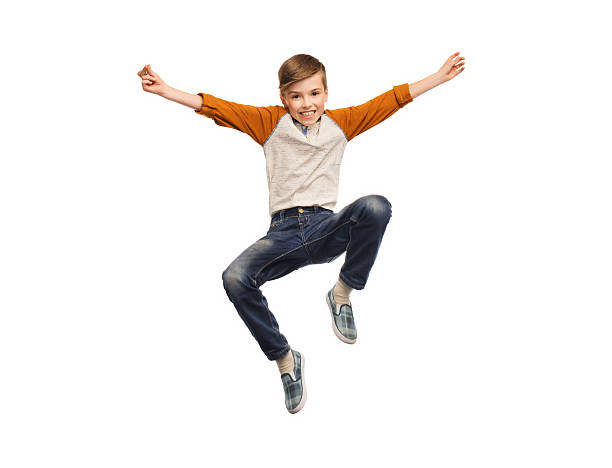 istock happy smiling boy jumping in air 501190780