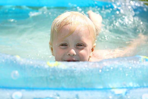 istock Happy Baby Playing in Swimming Pool 501192795
