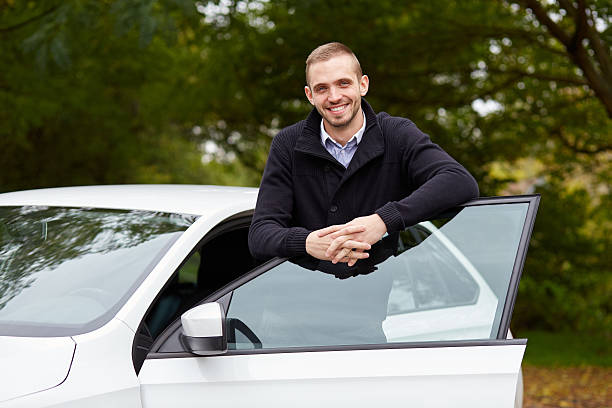 istock Handsome man leaning on car door 501193482