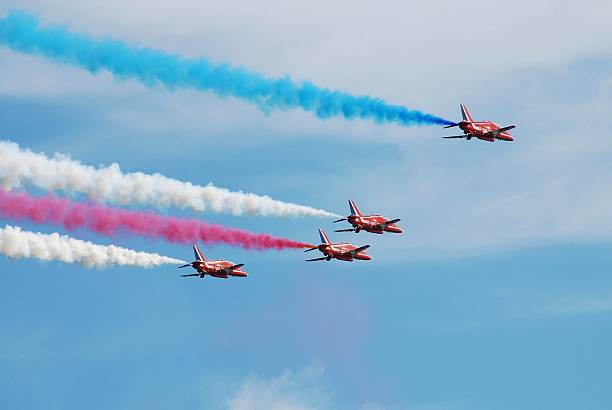 The Red Arrows Eastbourne, England - August 15, 2013: RAF aerobatic display team The Red Arrows perform at the annual free Airbourne airshow. The team was formed in 1965. british aerospace stock pictures, royalty-free photos & images