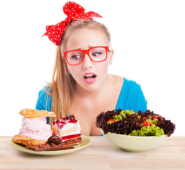 Difficult choice between junk and healthy food stock photo
