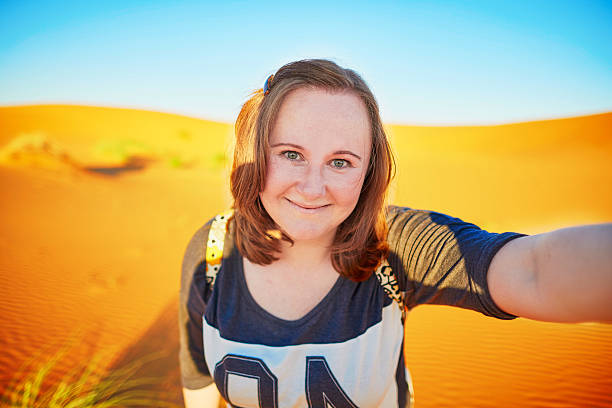 istock Happy tourist taking selfie with sand dunes in Sahara 501196146