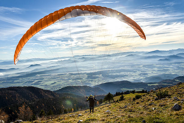 Paraglider is flying in the valley. Paragliding from the mountain with perfect view