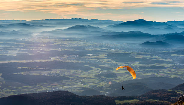 istock Paraglider is flying in the valley 501196260