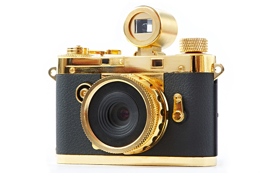 Mini gift golden camera isolated on white background