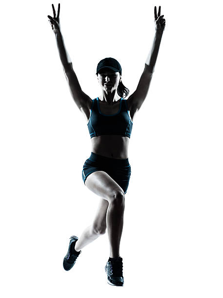 istock woman runner jogger jumping victorious silhouette 501196679