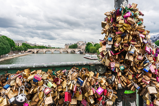 Love padlocks on the bridge Pont des Arts across river Seine in Paris, France. 