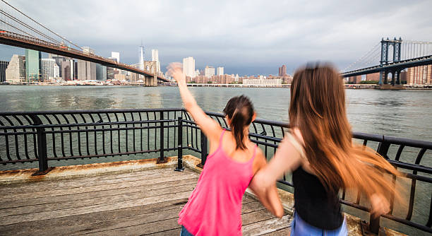 istock Two girls, sisters, looking to Manhattan under thunderstorm 501197097