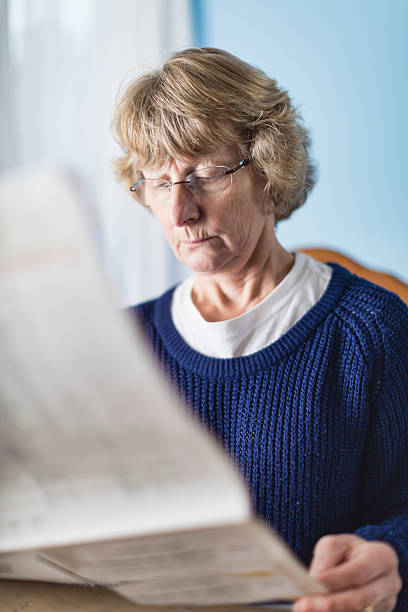 istock Lady In Her Sixties Reading The Morning Newspaper 501198070