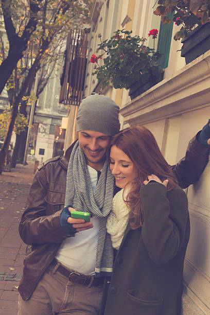 istock Couple in love using cellphone outdoors. 501198750