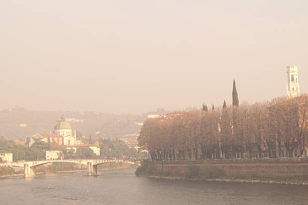 Adige River bridges and the dome chapel of Verona in the light of the December sun
