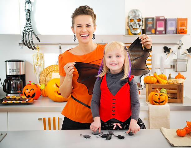 istock Funny halloween dressed girl with mother in kitchen 501199362