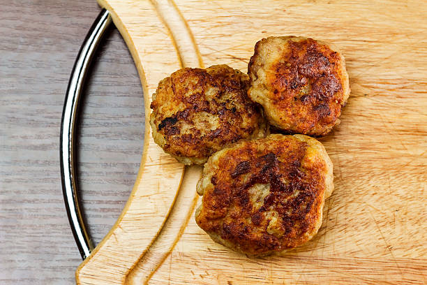 istock Fried meat cutlets on wooden cutting board, top view 501200486