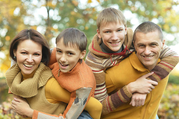 istock Family relaxing in autumn park 501202072