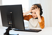 terrified boy with computer and headphones at home