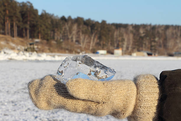 istock Ice crystal in the female hands dressed in woolen mittens 501202588