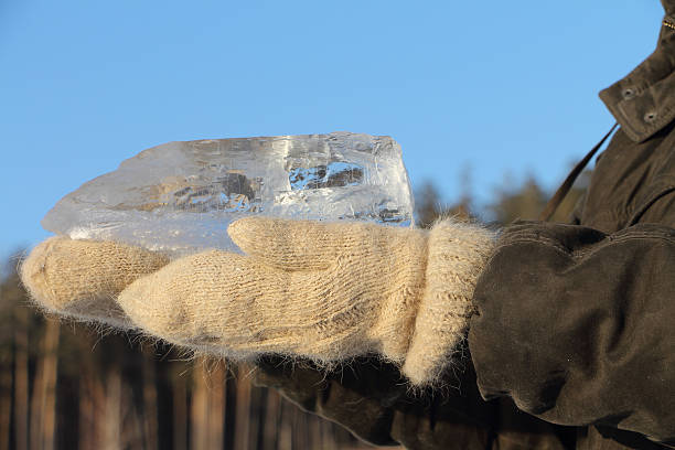 istock Ice crystal in the female hands dressed in woolen mittens 501202634