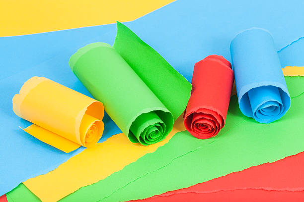 istock rolled colour paper on sheets of torn paper 501203472