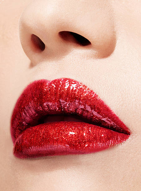 Beautiful lips with lipstick and lipgloss. Closeup. stock photo