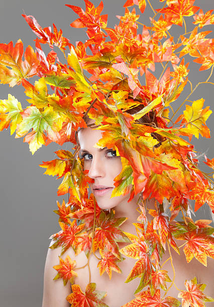 istock Beautiful woman wrapped in autumn leafs 501204576