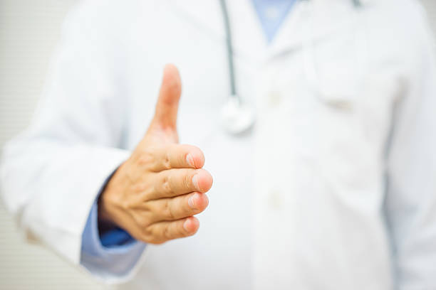 istock doctor is offering a hand to patient for partnership 501204842