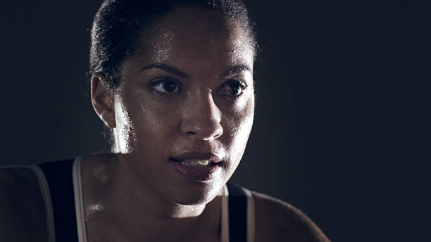 Female athlete portrait against black
