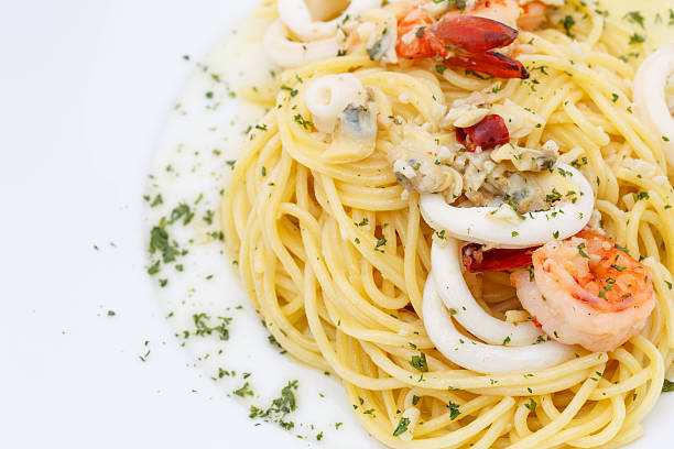 istock Delicious Spaghetti with Seafood on white plate 501205445