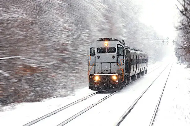 Photo of US loco push-pull commuter train motion in winter snow