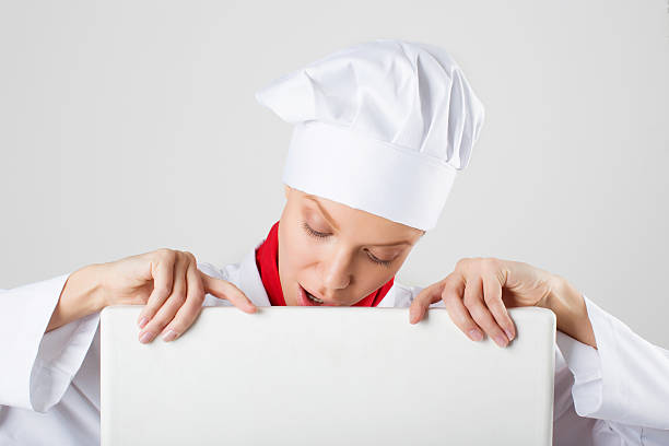 istock Chef or baker woman showing blank empty billboard sign. 501208003