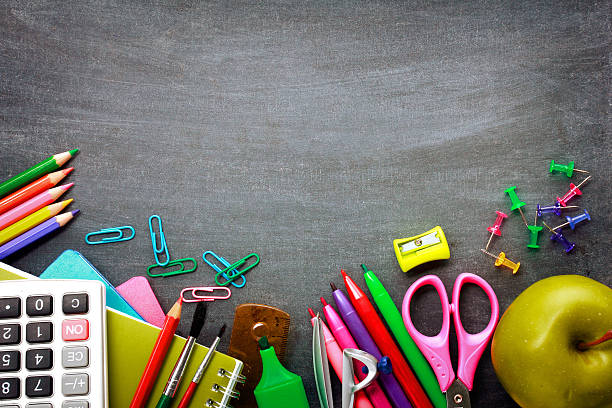 istock School supplies on blackboard background 501208219