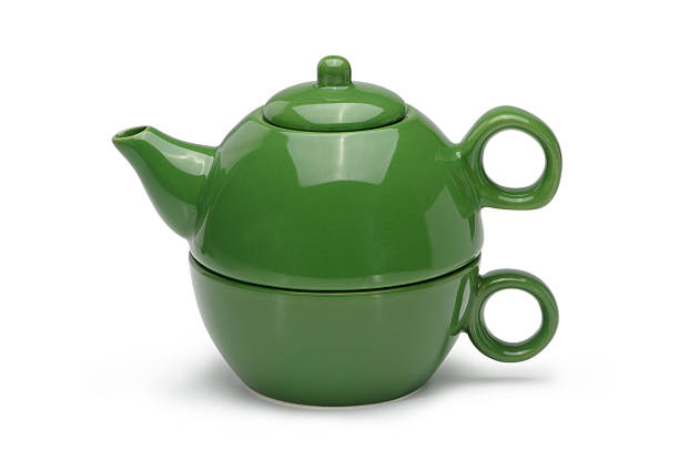 istock Set of a green ceramic teapot and mug. 501209493