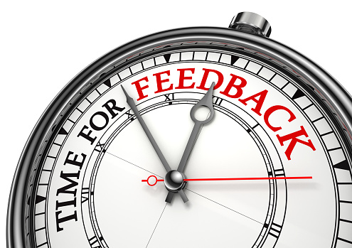 time for feedback concept clock on white background with red and black words