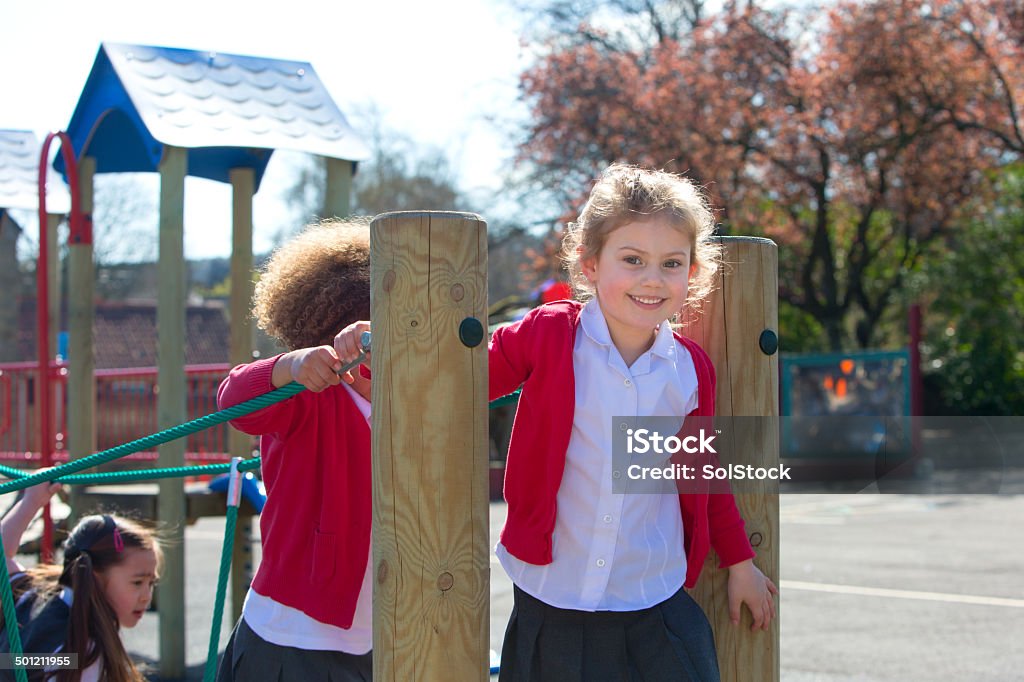 Active Kids School children at break time playing on climbing frame Child Stock Photo